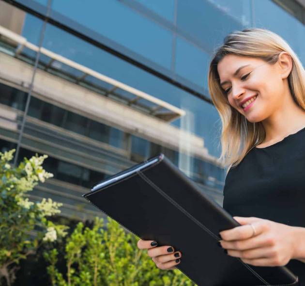 business-woman-holding-clipboard-and-standing-outdoors-.jpg